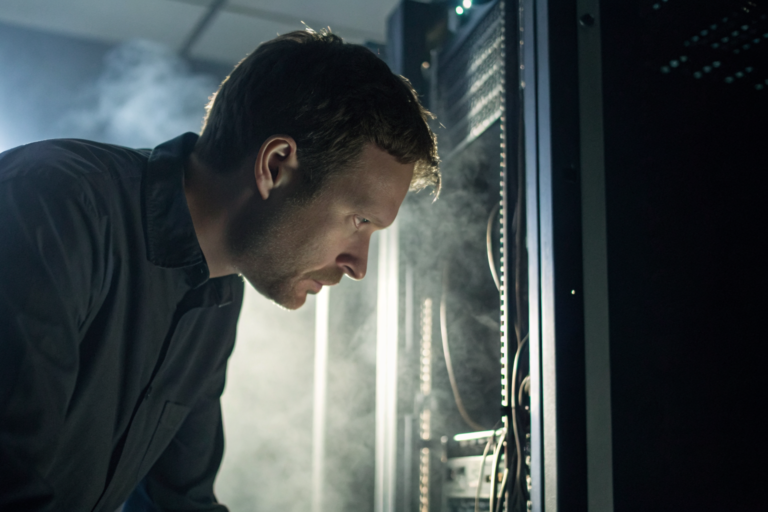 IT technician examining computer hardware with 'Litigation Hold' tags in a dim data center.