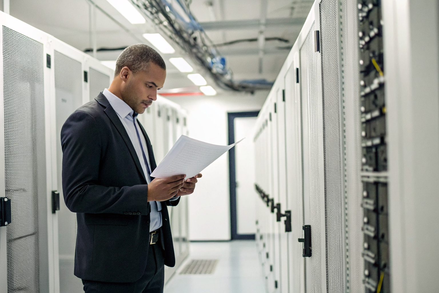 Auditor in a secure facility reviewing certification documents.